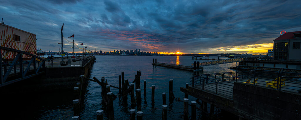 Sunset over Burrard Inlet with views of Vancouver’s skyline from the Lonsdale Quay.